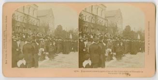 Pictures show a crowd of people waiting outside a large, Victorian building.