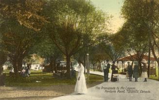 Colorized photograph of a woman in a white dress walking along a boardwalk in a park.