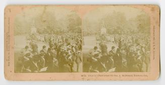 Pictures show a huge crowd gathered around a monument in a park.