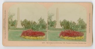 Pictures show a stone obelisk in a park with trees and foliage.
