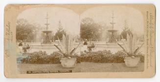 Pictures show a large fountain in a formal garden. People are sitting on a bench.