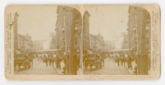 Pictures show a busy downtown street with pedestrians and horse drawn vehicles.