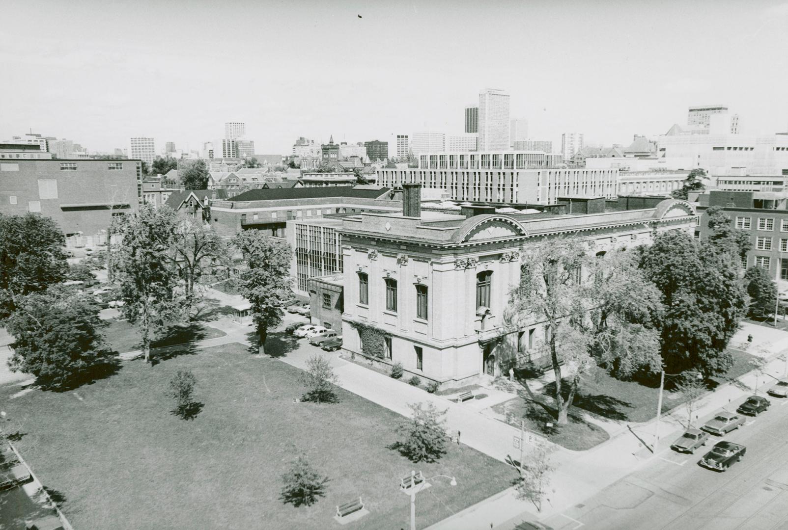 High view of library building, lawn, street and other buildings/