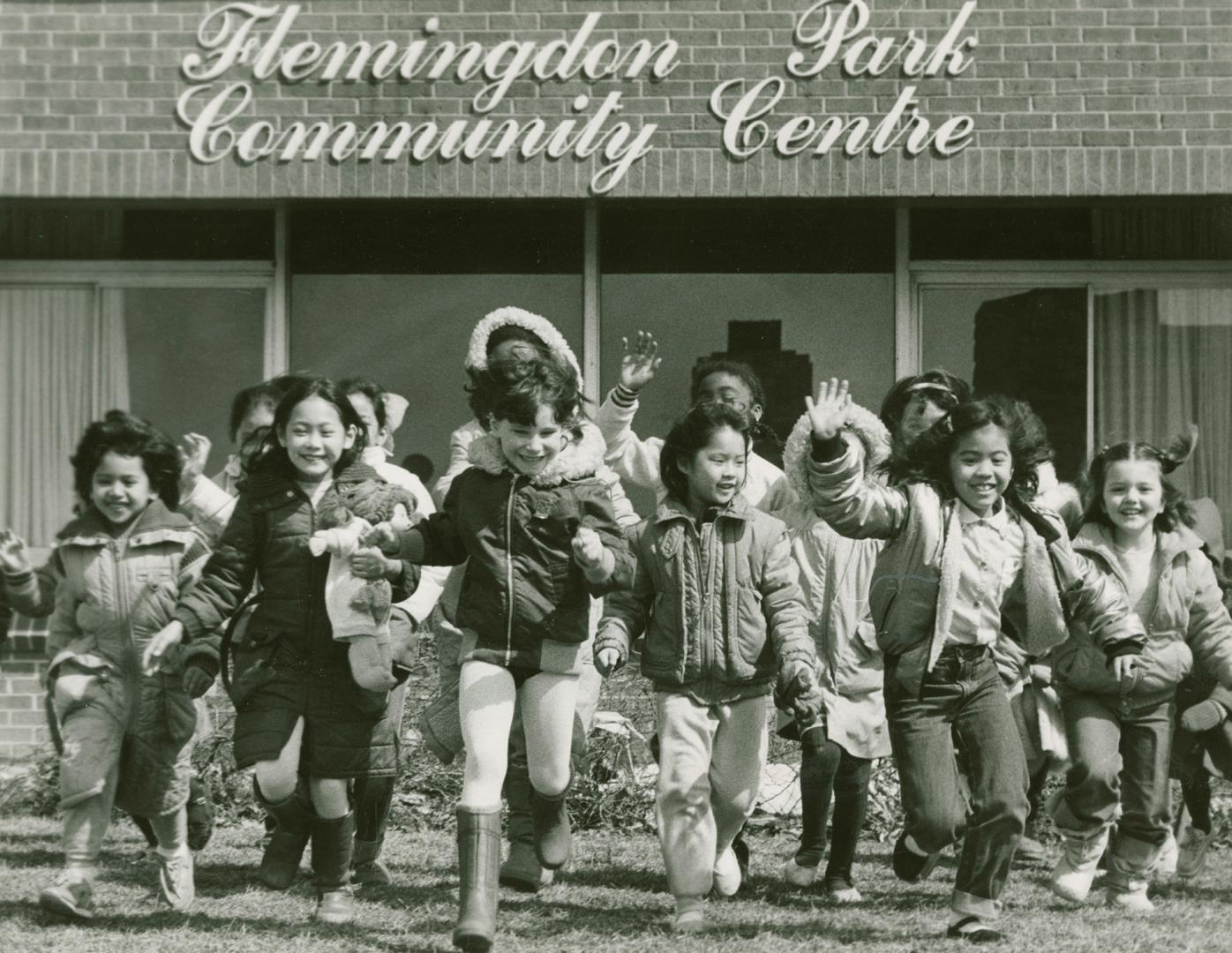 Photograph of children playing in from of the Flemingdon Park Community Centre (black and white…