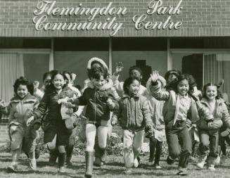 Photograph of children playing in from of the Flemingdon Park Community Centre (black and white ...