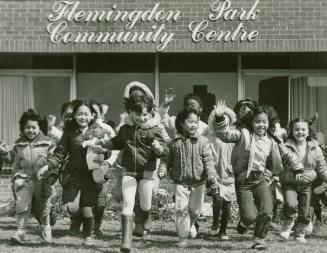 Photograph of children playing in from of the Flemingdon Park Community Centre (black and white…