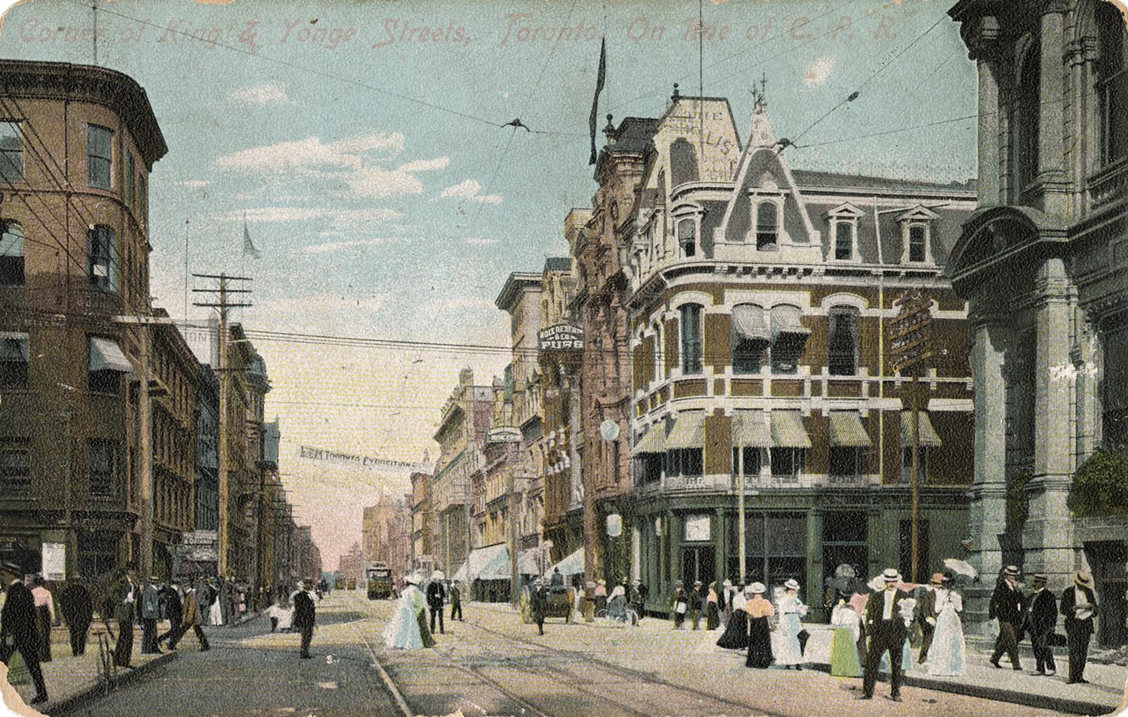 Colorized photograph of a busy downtown street wit many pedestrians.
