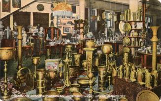 Colorized photograph of a huge number of brass object on display in a store showroom.
