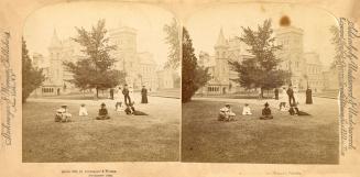 Pictures show people sitting on a lawn in front of a huge Victorian building with turrets and t ...