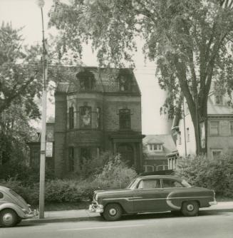 Street view of Boys and Girls House with car parked in front on the street. 