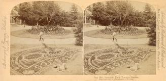 Pictures show a huge sun dial made of flowers in a well manicured park.