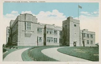 Colorized photograph of a two story rectangular school building. Grey stone walls.