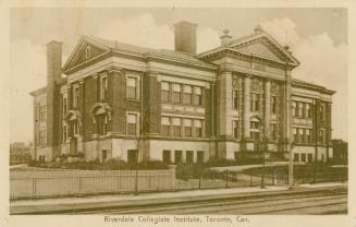 Sepia toned photograph of a three story school building with classical columns at the front doo ...