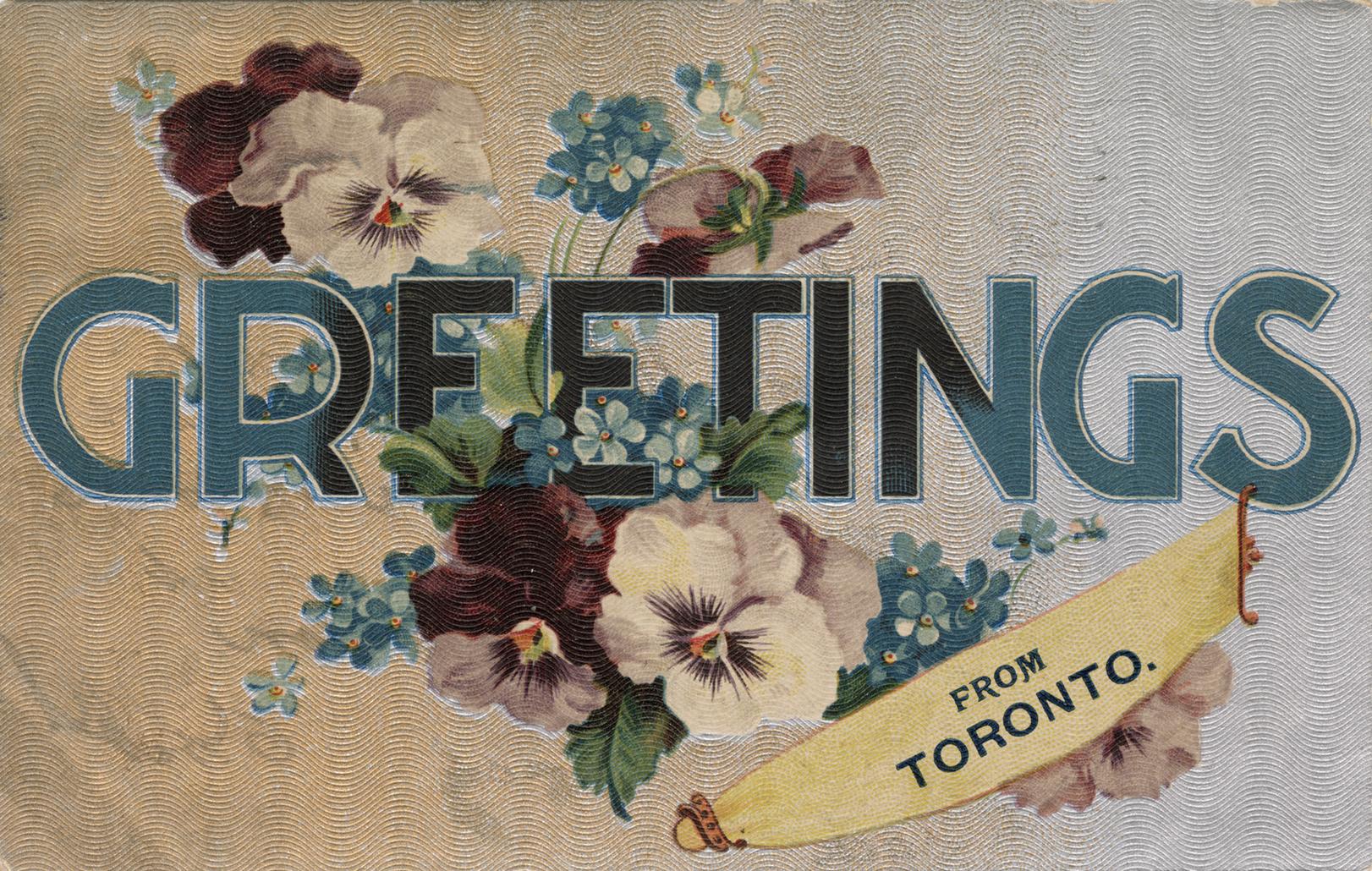 Purple and white pansies behind "Greetings" written in blue block letters.
