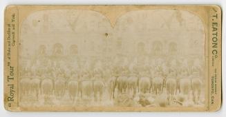 Pictures show soldiers on horseback lining the street in front of a Richardsonian Romanesque bu ...