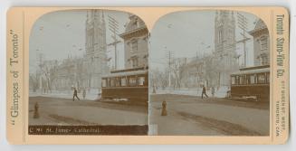 Pictures how a streetcar and pedestrians on the road in front of a large gothic church.