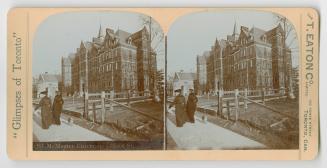 Pictures show two woman waling a pug dog on a path in from of a five story Victorian building.