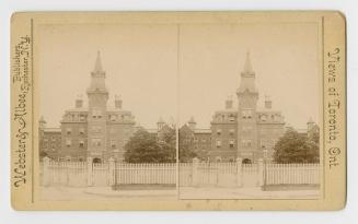 Pictures show a four story building with a central tower and steeple surrounded by a picket fen ...