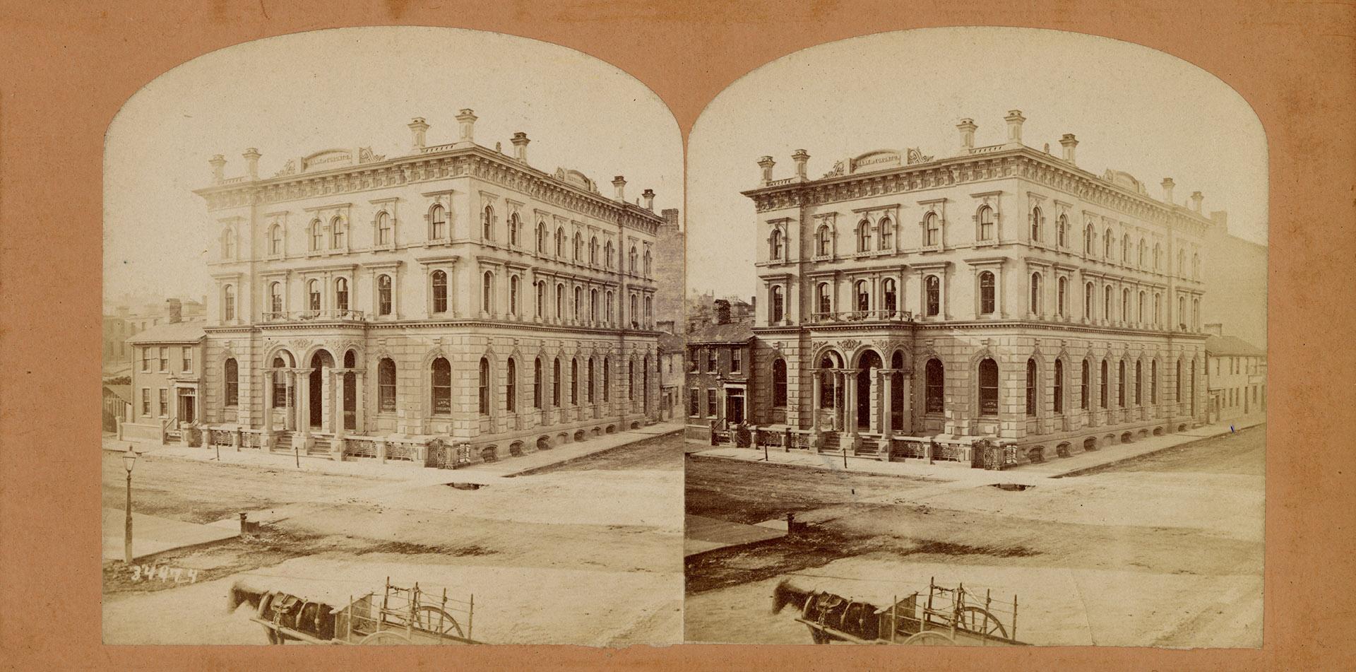 Pictures show a large three story stone building with a horse and wagon in front of it.