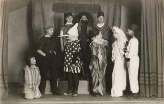 Group of children dressed in costumes for a play.