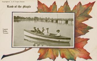 Picture of five people in a boat in a lagoon with a long wooden bridge in the background set in…