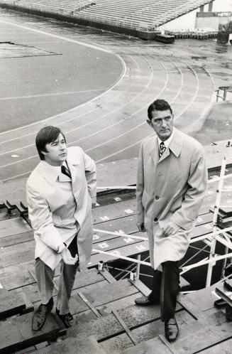 Dennis Mills (left), with his father, Alfred Mills, are standing on the extra seating their company installed at the CNE Stadium for the Grey Cup game(...)