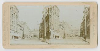 Pictures show a city street with tall buildings on either side.