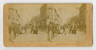 Pictures show pedestrians and horse drawn vehicles on a busy downtown street.