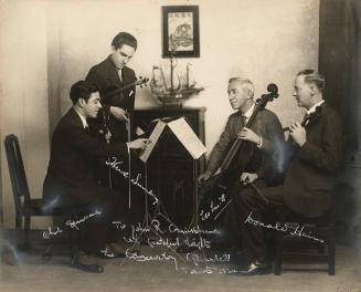 A photograph of four men, members of the Conservatory String Quartet. Two of them are holding v ...