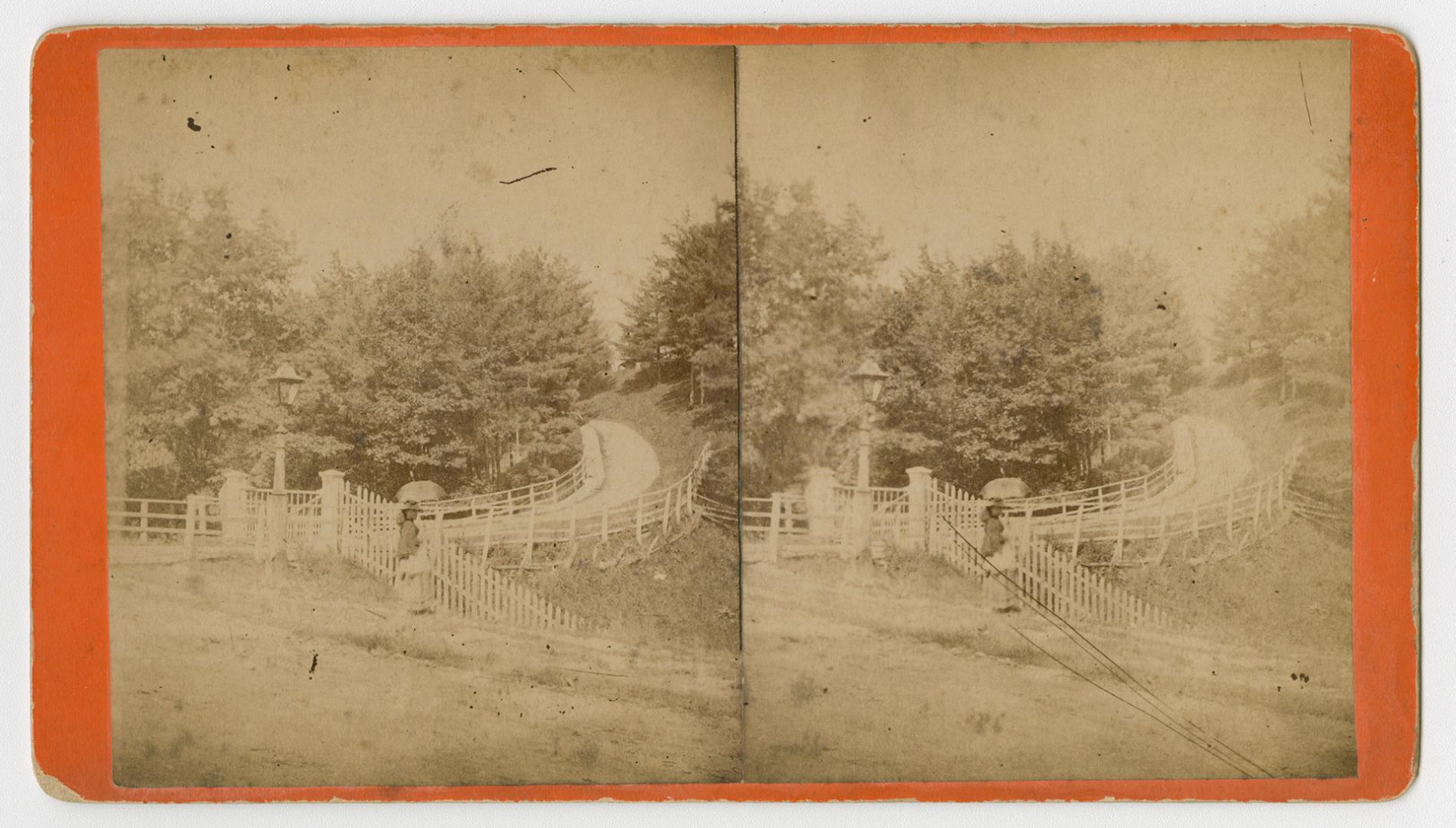 Pictures show a woman on a staircase climbing up a hill to a road with fences on either side of…