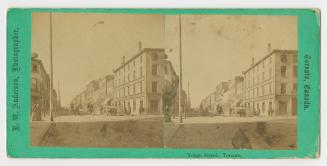 Pictures show a crossing of two city street with large buildings on all sides.