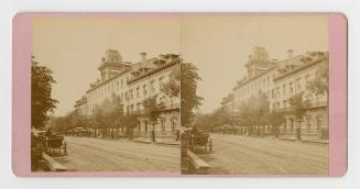 Pictures show a fours story hotel with trees and a horse drawn vehicle in front of it.