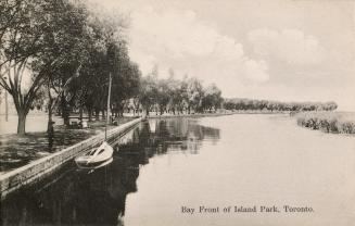 Black and white photograph of a narrow waterway with a park and marsh on either side.
