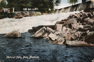 Colorized photograph of water rushing over jagged rocks.