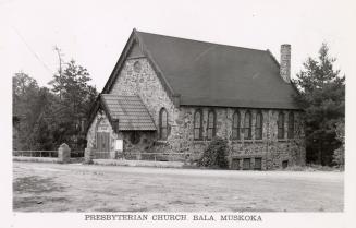 Black and white picture of a stone country church.
