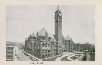 A photograph of a city hall and the immediate surrounding area, including streets to the left a ...