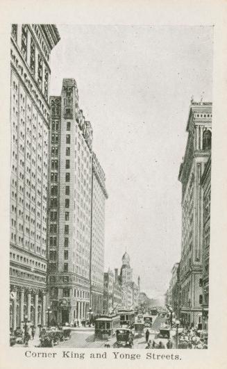 A photograph of a busy city street, with skyscrapers on both sides and the street filled with c ...