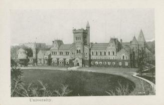 A photograph of a large university building with spires and turrets, and an oval-shaped grassy  ...