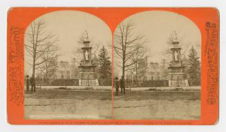 Pictures show two mean standing on the lawn in front of an Italian Renaissance style monument