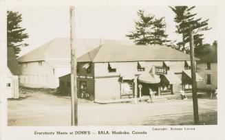 Black and white photograph of a two story restaurant building.