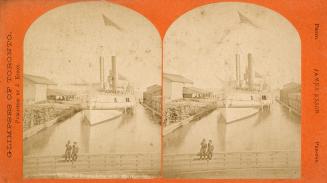 Stereo photograph showing two boys sitting on a fence on a dock with a steamship in the water b ...