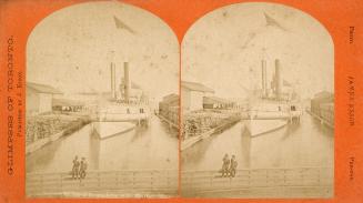 Stereo photograph showing two boys sitting on a fence on a dock with a steamship in the water b…