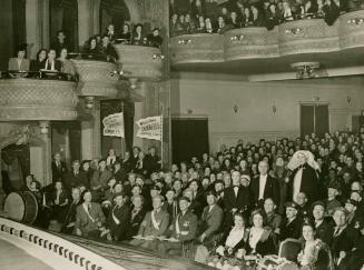 Black and white photograph of the audience of a Dumbells' performance in the Grand Theatre of C ...