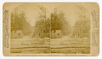 Pictures show a group of people standing in front of a gated, wide path into a wooded area. Str…