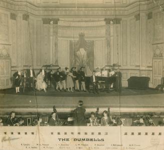 Black and white photograph the Dumbells on stage at the Coliseum Theatre, London, England.