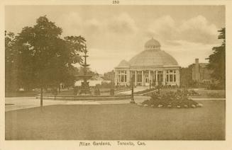 Sepia toned picture of a large domed building in a city garden.