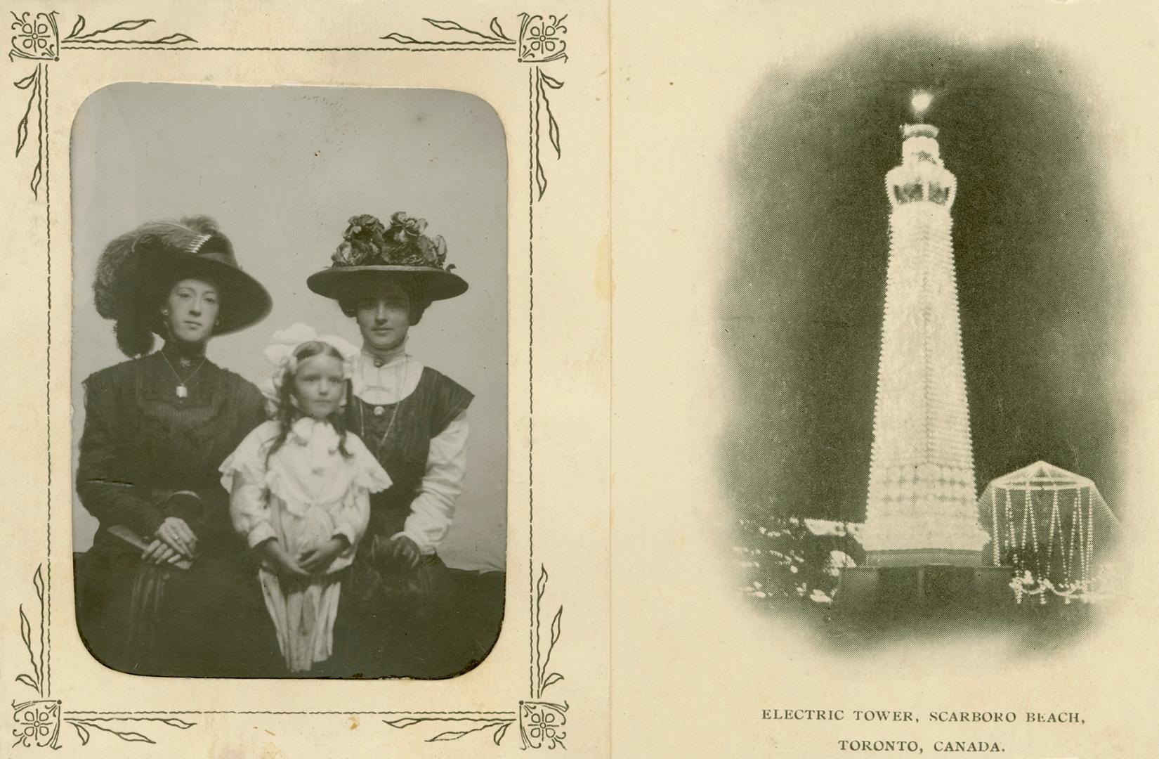 Two women and a child pose for a picture on the left and an illuminated tower is on the right.