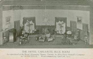 Furniture arranged on a stage to imitate a lounge in a hotel. Black and white.