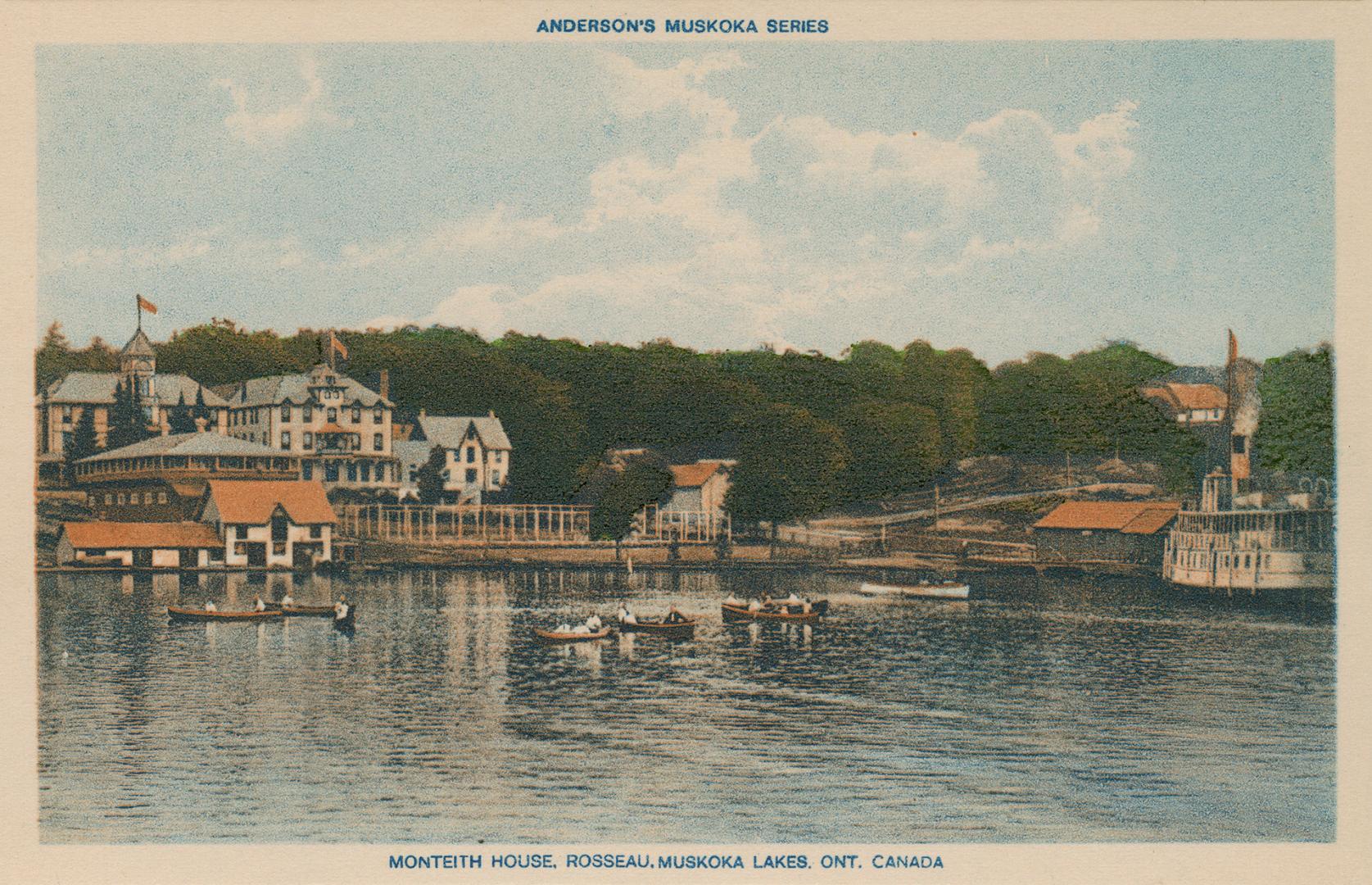 People in canoes sailing on a lake in front of a large hotel.