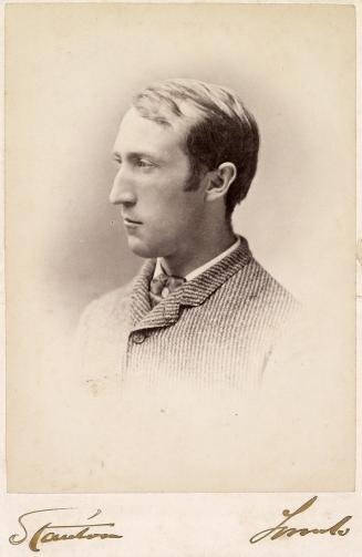 A cabinet card photograph of a middle-aged man, posed in a photography studio and visible from  ...